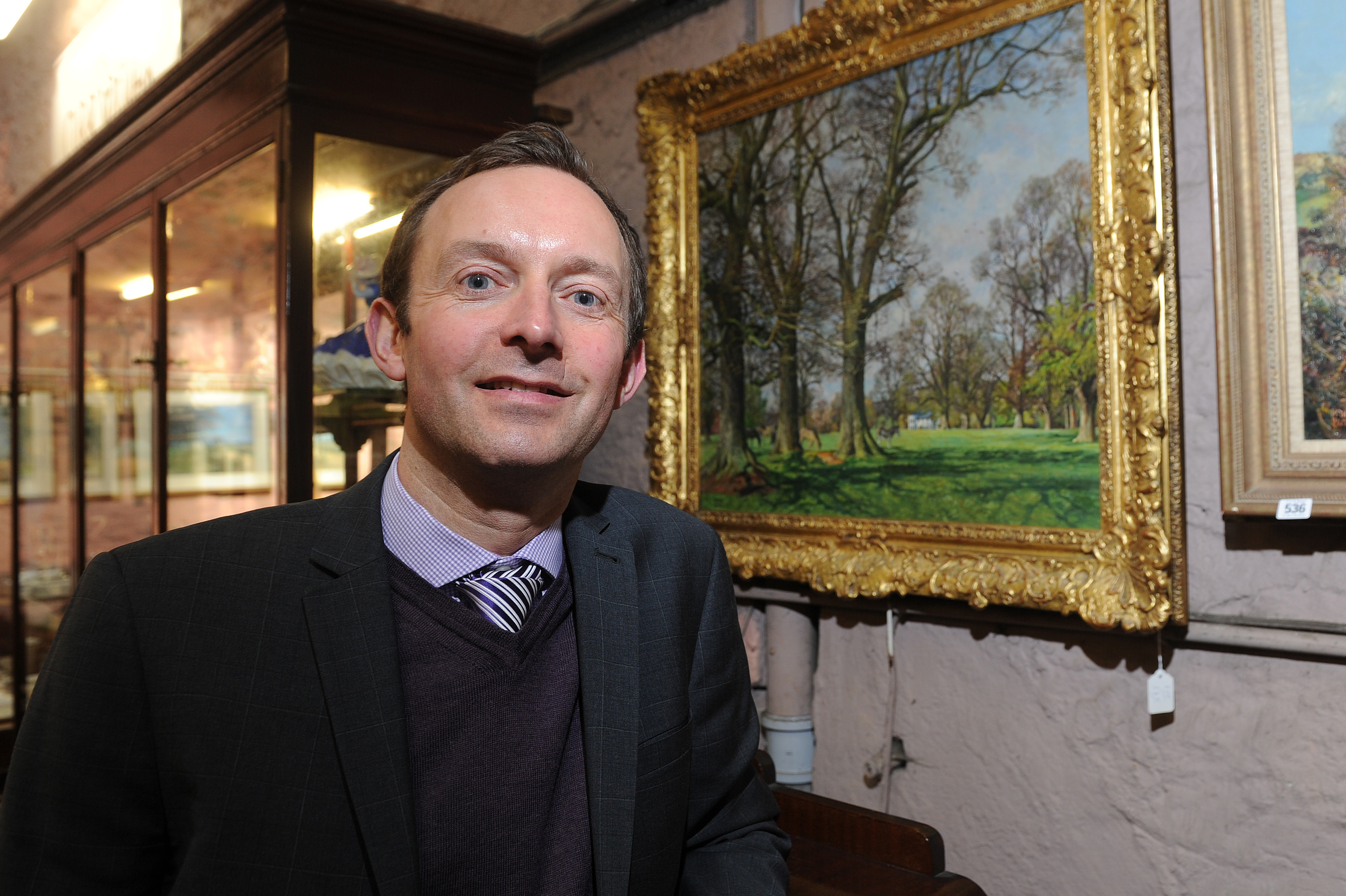 The auctioneers recently sold several McIntosh Patrick original paintings for almost £40,000. Picture shows Steven Dewar with one of the paintings