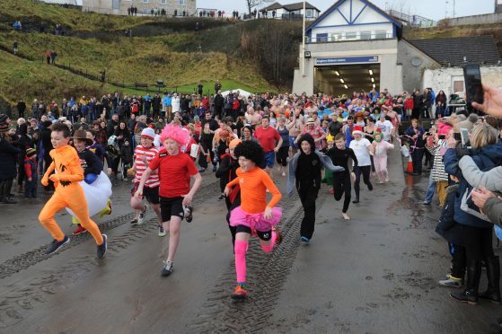 Some of the intrepid bathers run to the water.