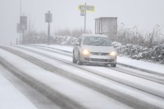 A car makes its way through the snow during the Beast from the East.