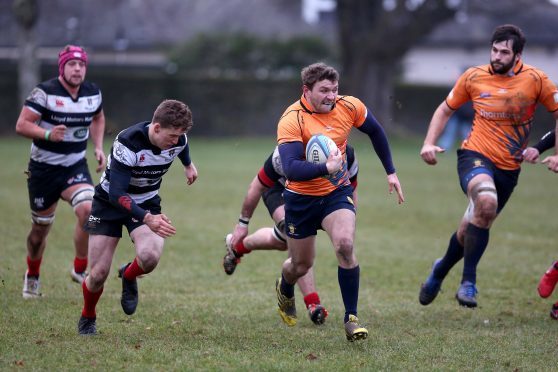 Neil Herron makes a rare clean break for Dundee High in their defeat to Kelso.