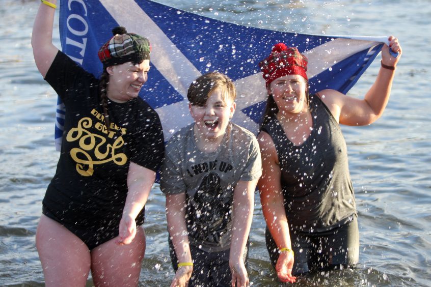 Susan Banks, Thomas Banks-Morrison and Clare Hart in the water at Broughty Ferry