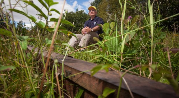 Dr Allen Armstrong, Secretary of the Levenmouth Rail Campaign at the site of the overgrown railway