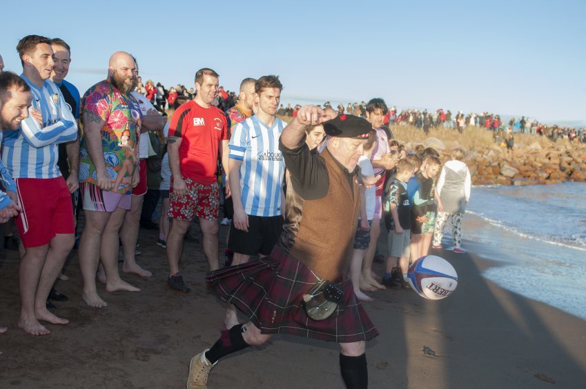 Carnoustie's New Year Dook. Rob Bruce, President of the rugby club kicks off the event.