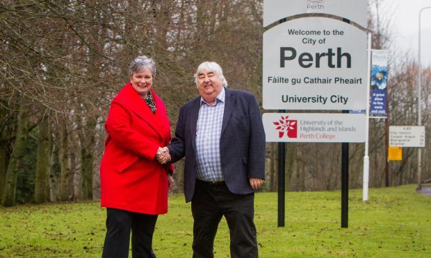 Margaret Cook (Principal of Perth College UHI) and Councillor Ian Campbell (leader of Perth & Kinross Council) at the new sign on the A85.