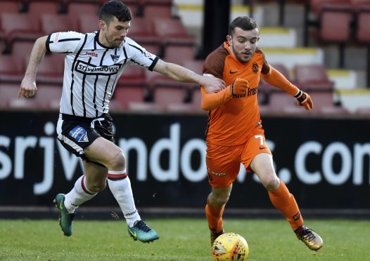United player Paul McMullan tries to skip past Jason Talbot of the Pars.