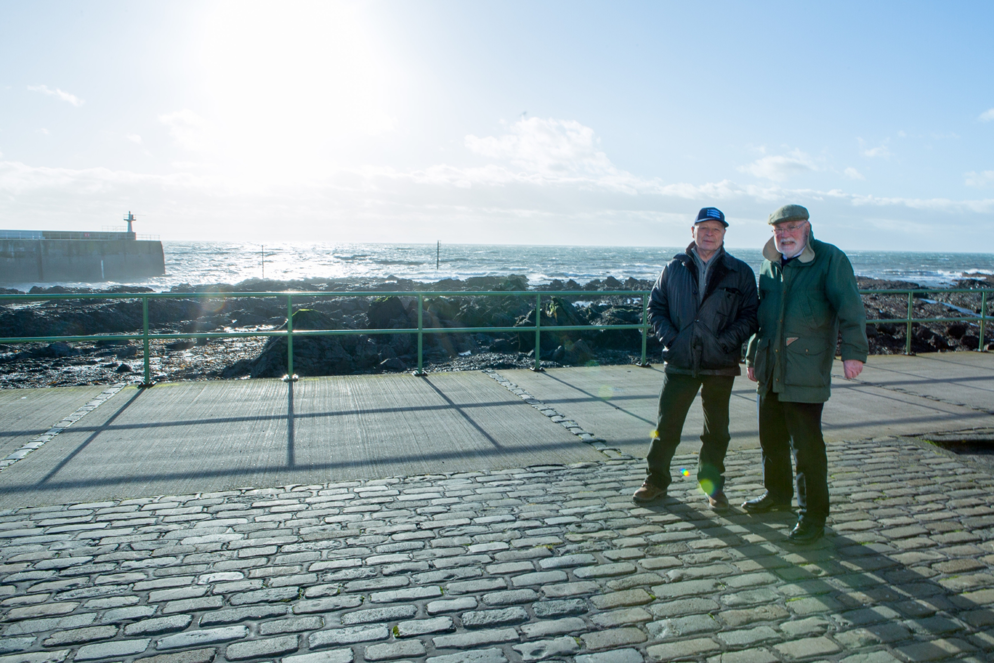 Former skipper Ronnie Hughes (69) and Wullie McNaughton (71) at Pittenweem harbour where the memorial to fishermen lost at sea is proposed to be located.