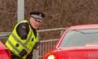 Police warn drivers of parking improperly outside the school last week.