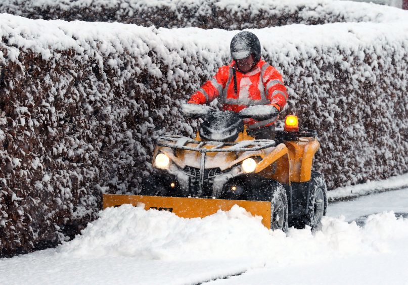 Jim Dunbar clears the snow in Braco, Perthshire.