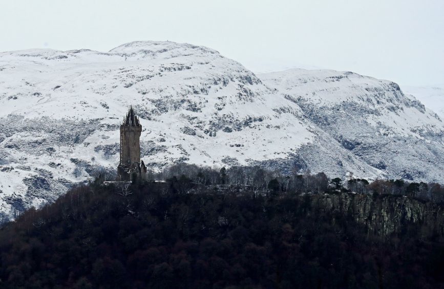 A view of the snow-covered Ochil Hills behind the Wallace Monument in Stirling, as parts of the country were blanketed in a layer of snow.