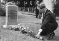 Ian Robertson placing flowers at the grave of the "unknown bairn" of Tayport.