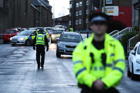 Police at the cordon on Mains Road, where John Ogston was found on New Year's Day.