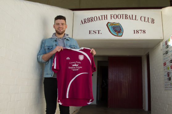 Dundee defender Kerr Waddell, who was mentored by John McGlashan, with the shirt.