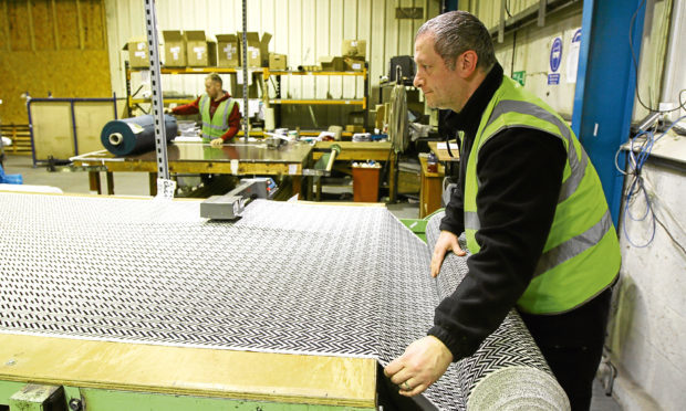 A technician cuts fabric at Sekers Fabrics workshop at Wester Gourdie Industrial Estate, Dundee.