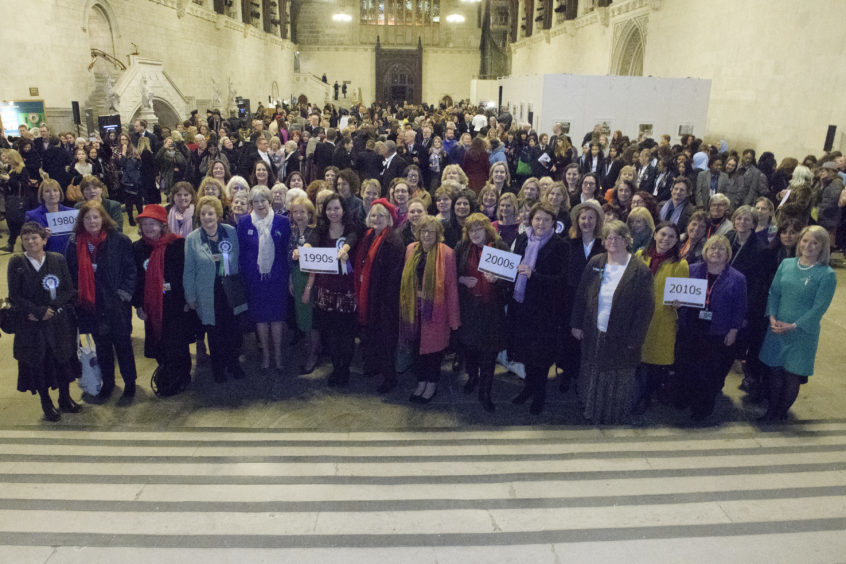 Prime Minister Theresa May (fifth from left) poses with female parliamentarians past and present to celebrate the Centenary of the Representation of the People Act, 1918.