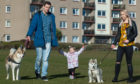 Roksana Cernicka, husband Miroslav Cernicky and toddler daughter Emily, with their dogs Aurora and Habbana.