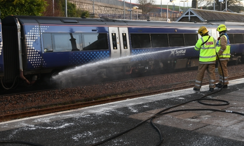 Firefighters dampening down the train at Cupar.