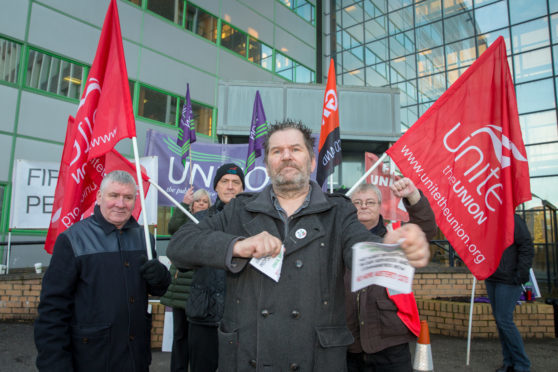 Tam Kirby rips up a booklet of promises made by Fife councillors at a trade union led protest before Fife Council's budget meeting in Glenrothes.