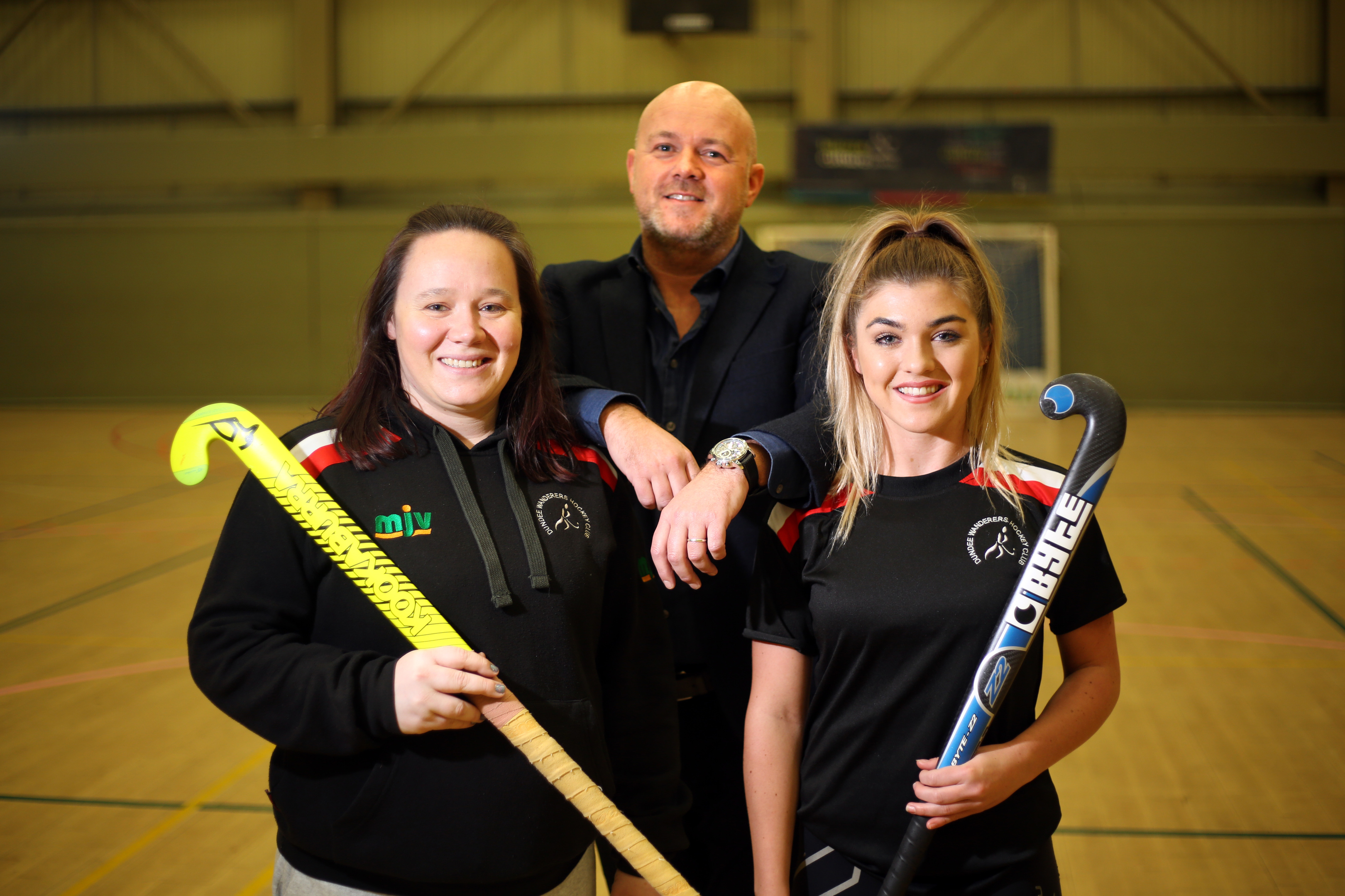 Sam Sangster and Jess Ross from Dundee Wanderers Hockey Club with Richard Kilcullen, the managing director of Kilmac.