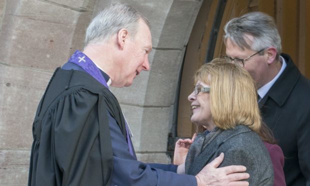 The Rev John Murdoch consoles Mr Campbell's wife Pam.