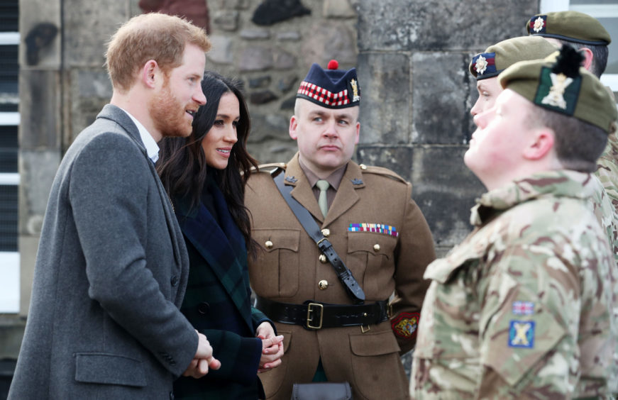 Prince Harry and Meghan Markle meet the gunners before the firing of the One O'Clock Gun at Edinburgh Castle