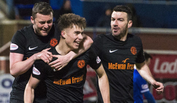 Matty Smith celebrates with Tam Scobbie and Paul Quinn after making it 3-1.