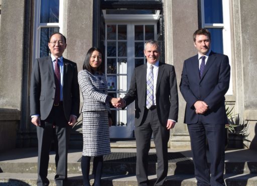 On the front steps of Craigclowan, left to right, Pan Xinchun, Consul General; Guifang Lou, Chair of LUKEC; Bill Farrar, chair of the board of governors of Craigclowan School and headmaster John Gilmour.