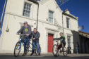 Project Director Scott Francis(left) on a tandem with volunteer Jeff Williams and community mechanic Calum Watson (right) outside the new premises