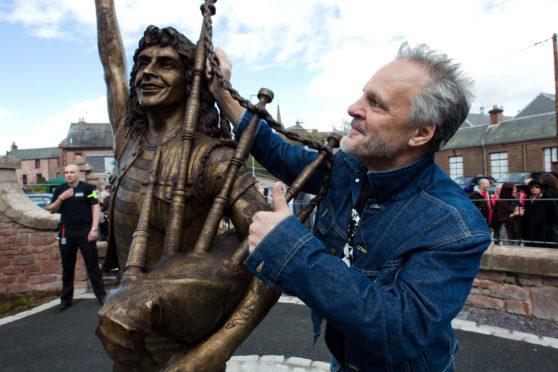 Former AC/DC bassist Mark Evans at the Bon Scott statue in Kirriemuir two years ago.