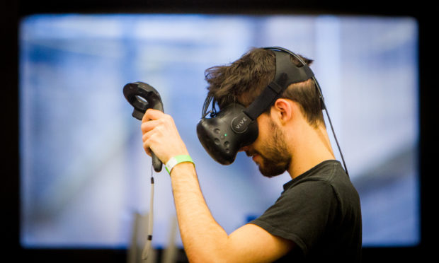 An Abertay University games student plays a virtual reality game.