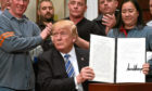 US President Donald Trump signs into law new tariffs on the import into the US of steel and aluminum.