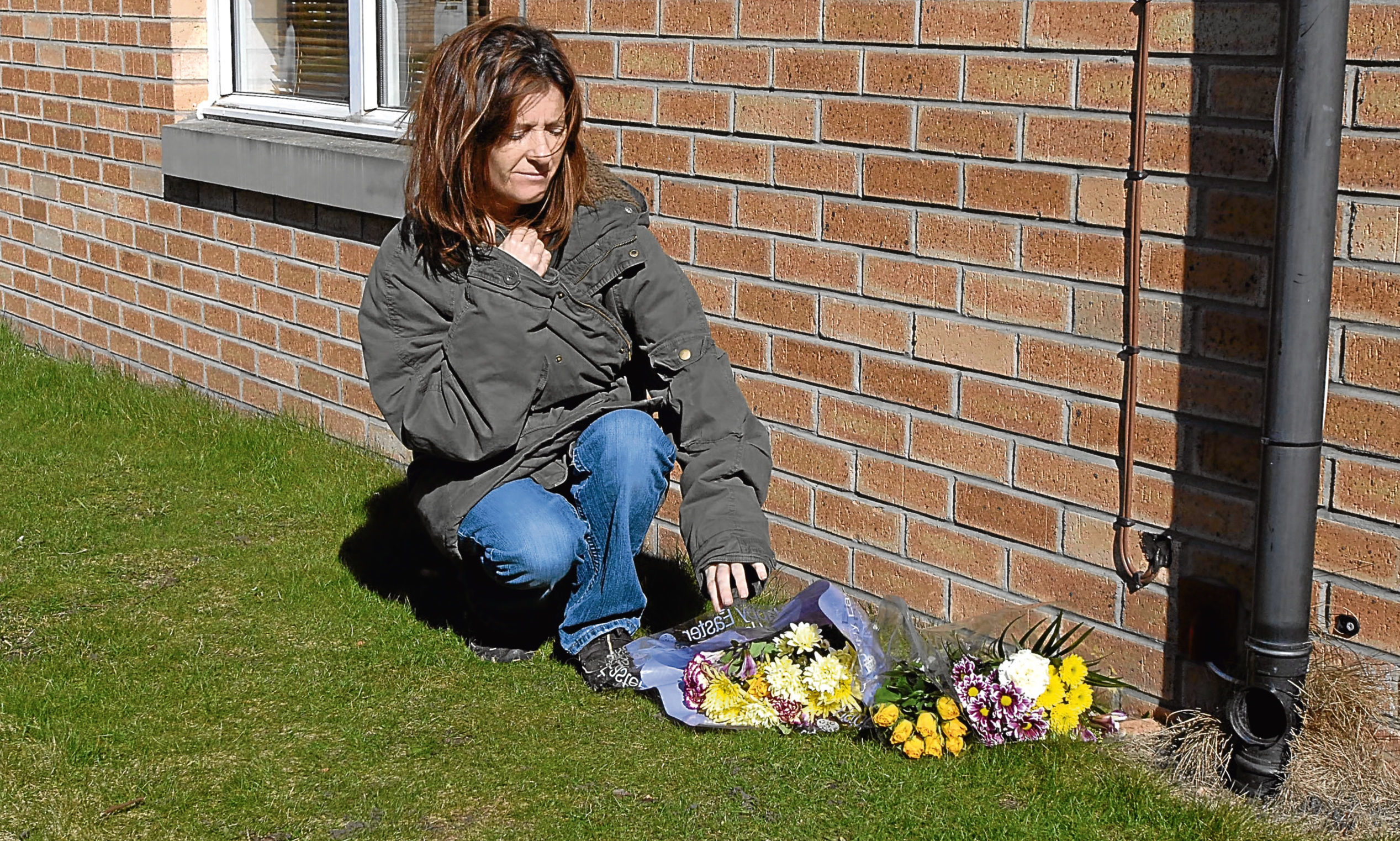Tracey Braithwaite, who found Sonya Todd’s body, lays flowers at the scene a decade ago.