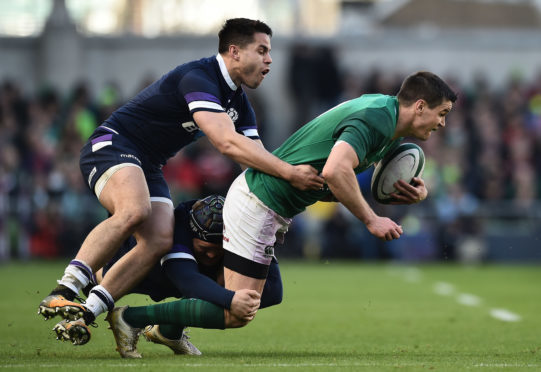 Sean Maitland tackles Johnny Sexton during Saturday's 6 Nations clash in Dublin.