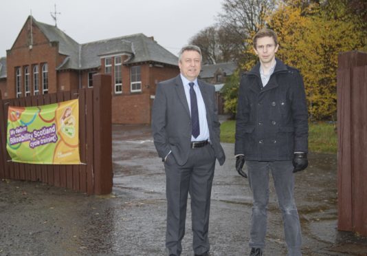 Councillors Angus Forbes (left) and Alasdair Bailey outside Abernyte Primary.