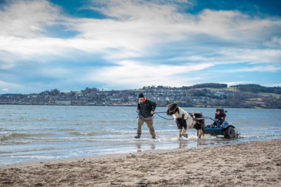 Simon and Obama taking 10-year-old Kevin for a ride on Broughty Ferry beach.