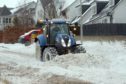 Tractors helping to clear snow on Balmossie Brae in Dundee.