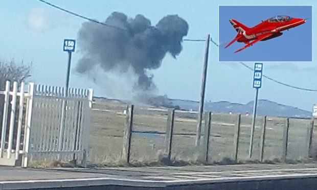 A photo issued by Sian Rebecca Williams of smoke rising after a Red Arrows jet crashed following an incident at RAF Valley in north Wales. Inset: a Red Arrows jet.