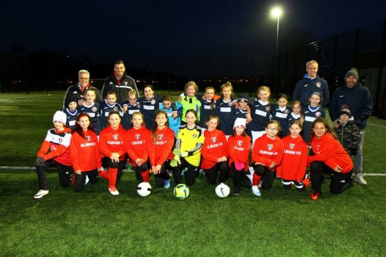 The girls of Albion FC, front row, from Vancouver, Canada, and Dundee East Girls U-11's with their coaches, before their challenge match
