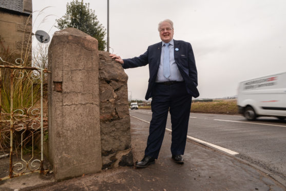 David MacDiarmid stands by the wall which will be re-modeled to allow motorists better visibility at the crosskeys junction, Freuchie.