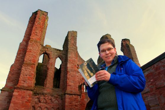 Mr Deak with a Sir Walter Scott novel at his beloved Arbroath Abbey.