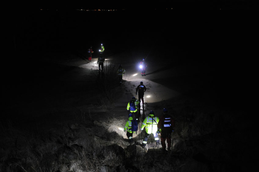 Rescuers arrive on the beach on Wednesday evening
