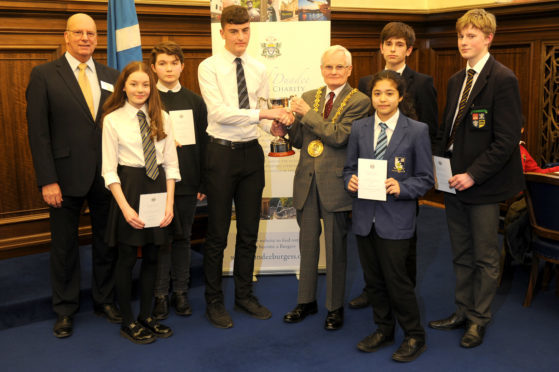Lewis Neilson receives the trophy from Lord Provost Ian Borthwick and City of Dundee Burgess Charity chairman Brian McLeod (left). Also pictured are pupils Molly Dickson of Morgan Academy (worth of mention), Lucy Johnston of St Paul's RC Academy (third place), Emily Crawford of Grove Academy (second place) and Daniel Hamilton and Anthony Mills of Dundee High School (both worthy of mention).