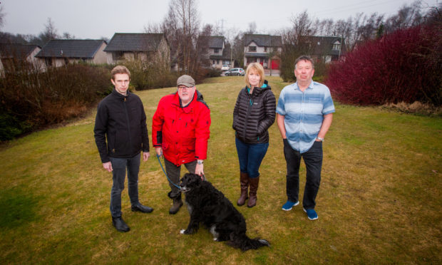 Some Longforgan residents who voiced their concerns about plans for a house on a recreation site: left to right is Councillor Alasdair Bailey alongside concerned residents Jim Gethins, his dog Corrie, Joanna McCormick and Doug Smith on the site. Mary Findlay Drive,