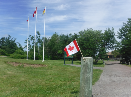 Flags at full flutter on the road from Shediac to Miramichi.