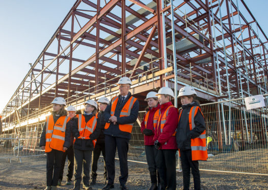 Bertha Park High School is one of the projects to help cater for a growing population - John Swinney MSP with come of the pupils from local feeder primary schools for the new school.