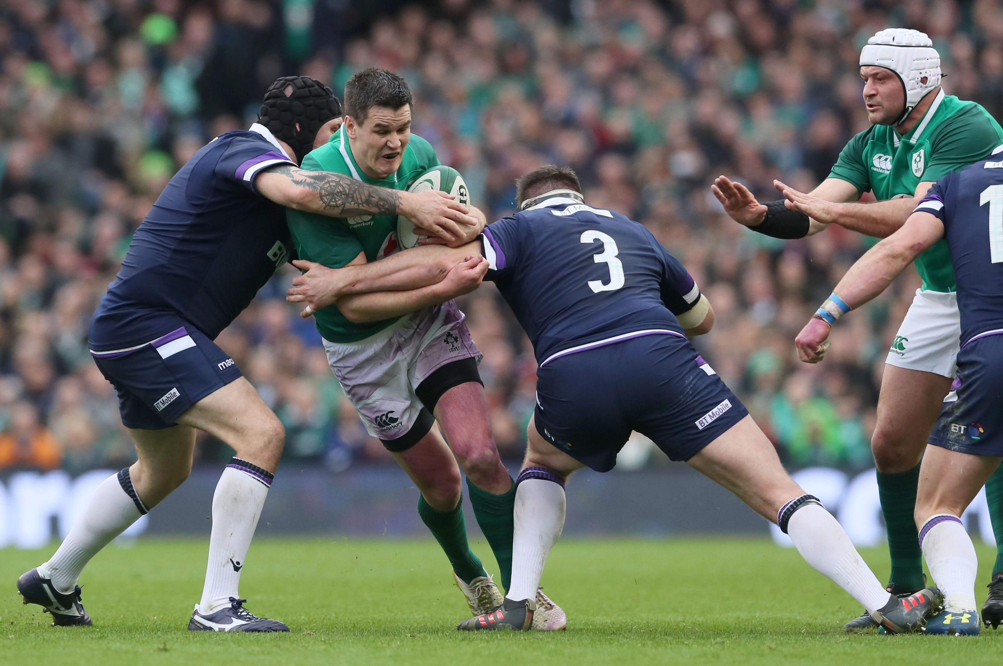 Johnny Sexton is tackled by Gordon Reid and Simon Berghan during Saturday's game in Dublin.