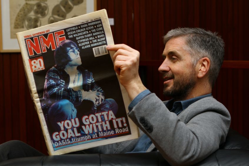 Roddy Isles sits down to read the NME with Oasis on the cover