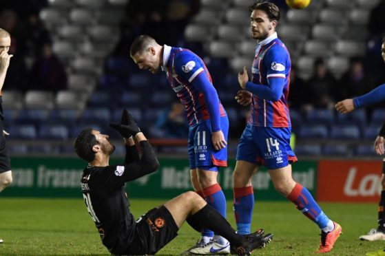 United defender Bilel Mohsni has a word with Iain Vigurs of ICT.