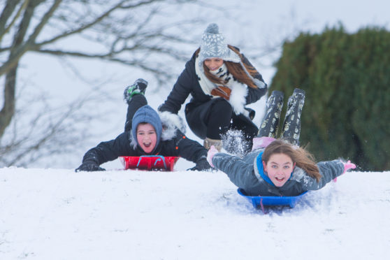 Children having fun sledging at Riverside Park in Glenrothes. The smiles will be bigger when they learn school is off until Monday.