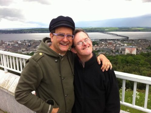 Timmy and his late brother Martin pictured on Dundee Law against the backdrop of the River Tay.