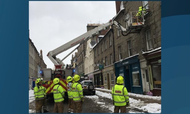 Firefighters tackle the icicles in George Street.